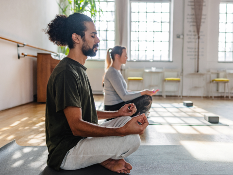 Nasal spray adult patient actor portrayal meditating in a yoga class